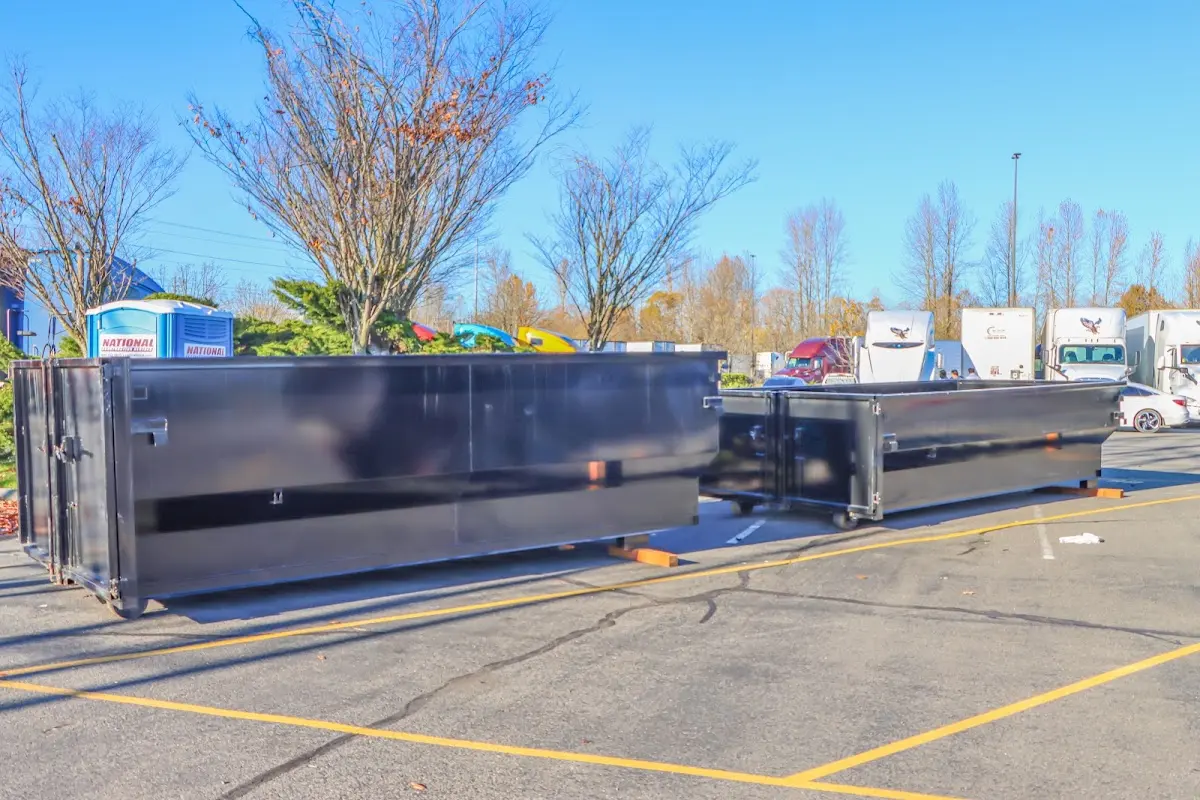 Professional dumpster rental service with roll-off container on residential driveway in Fort Atkinson